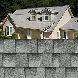 Timberline HDZ birchwood shingle closeup with sample product image on a beige house.