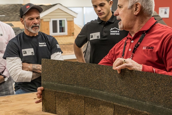 Roofing professionals and contractors at a CARE training class learning about shingles