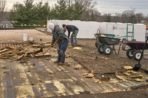 GAF Contractor removing roof waste on flat roof