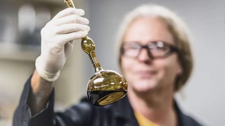 A GAF female scientist holding a fancy beaker with enclosed solution