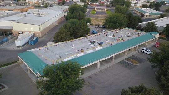 Arial shot of a mod-bit recover project on a commercial roof.