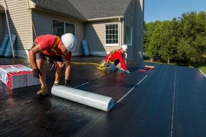 GAF contractors installing LIBERTY SBS Self-Adhering Base/Ply on flat roof.