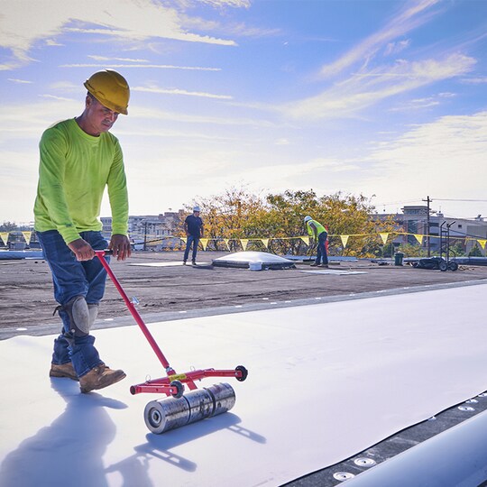 Roofing contractor installing GAF TPO membranes