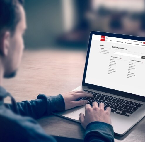 Man with laptop utilizing the GAF document library