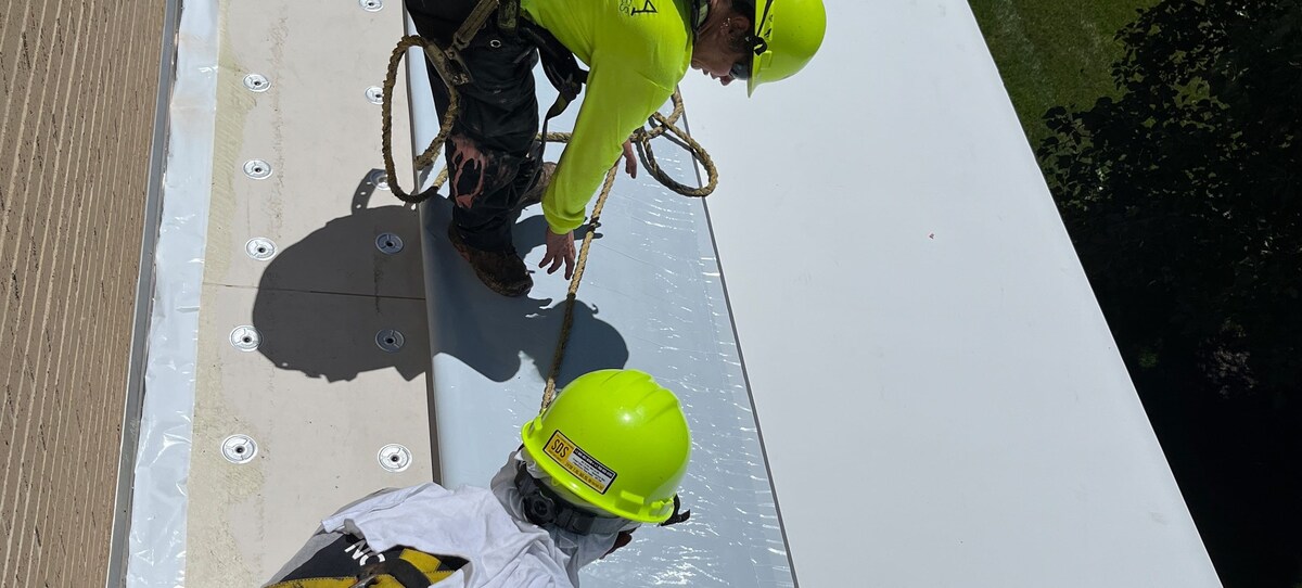 Construction workers applying new roof on Convention Center with GAF commercial roofing materials